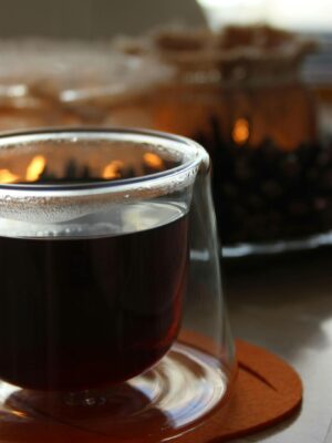 A sophisticated glass cup with rich black coffee, highlighting its elegance and warmth.